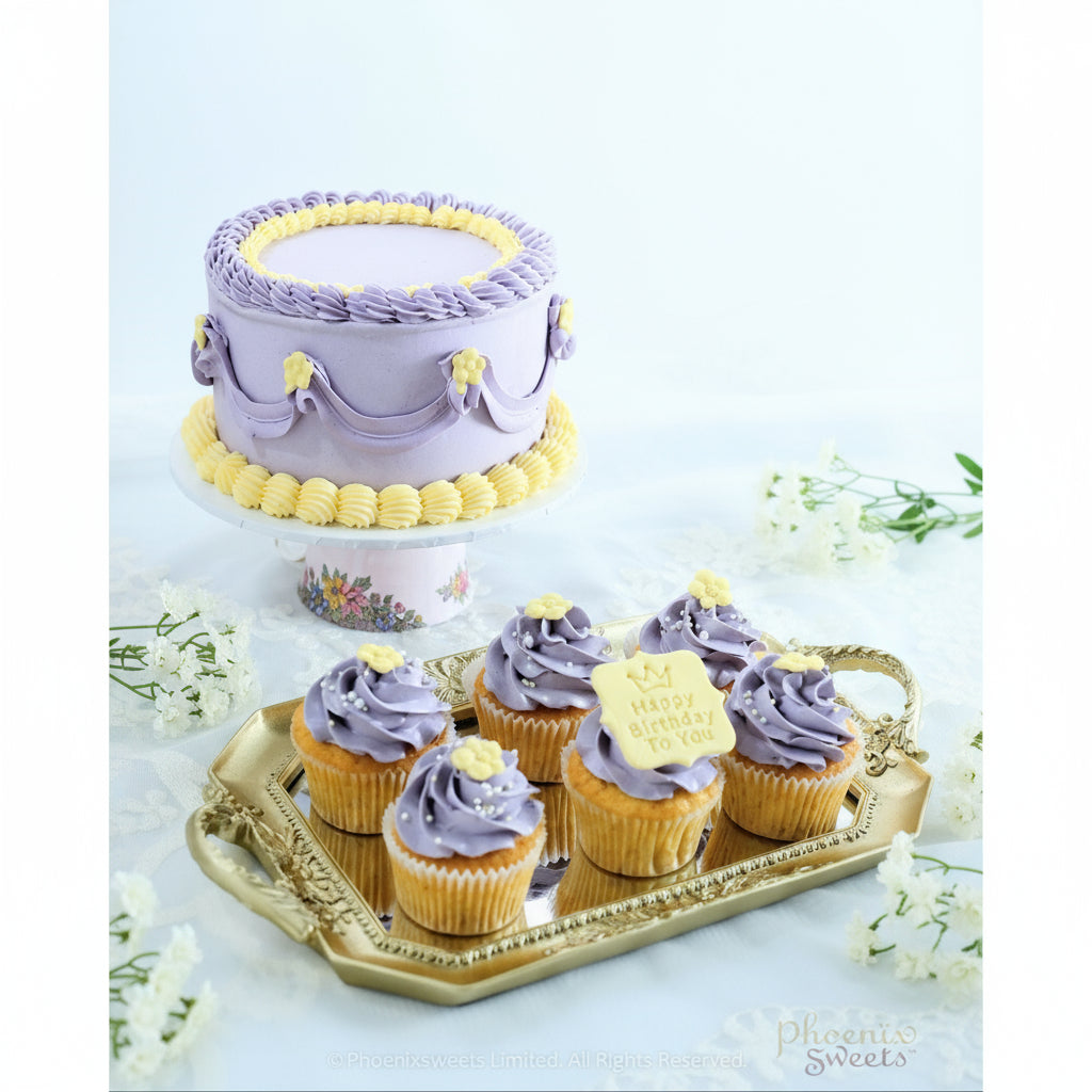 A set of cupcakes with buttercream frosting in a princess theme, with one cupcake topped with a small castle decoration.